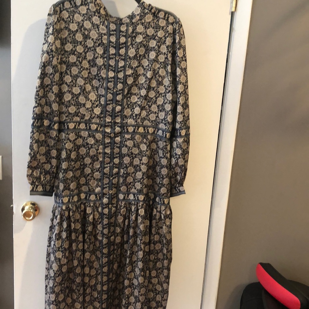 A beautiful conservative black and gold midi dress with long sleeves.